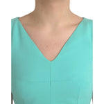 Close-up of a model wearing a Dolce & Gabbana Green Viscose Sleeveless Sheath Midi Dress showing the V-neck design.