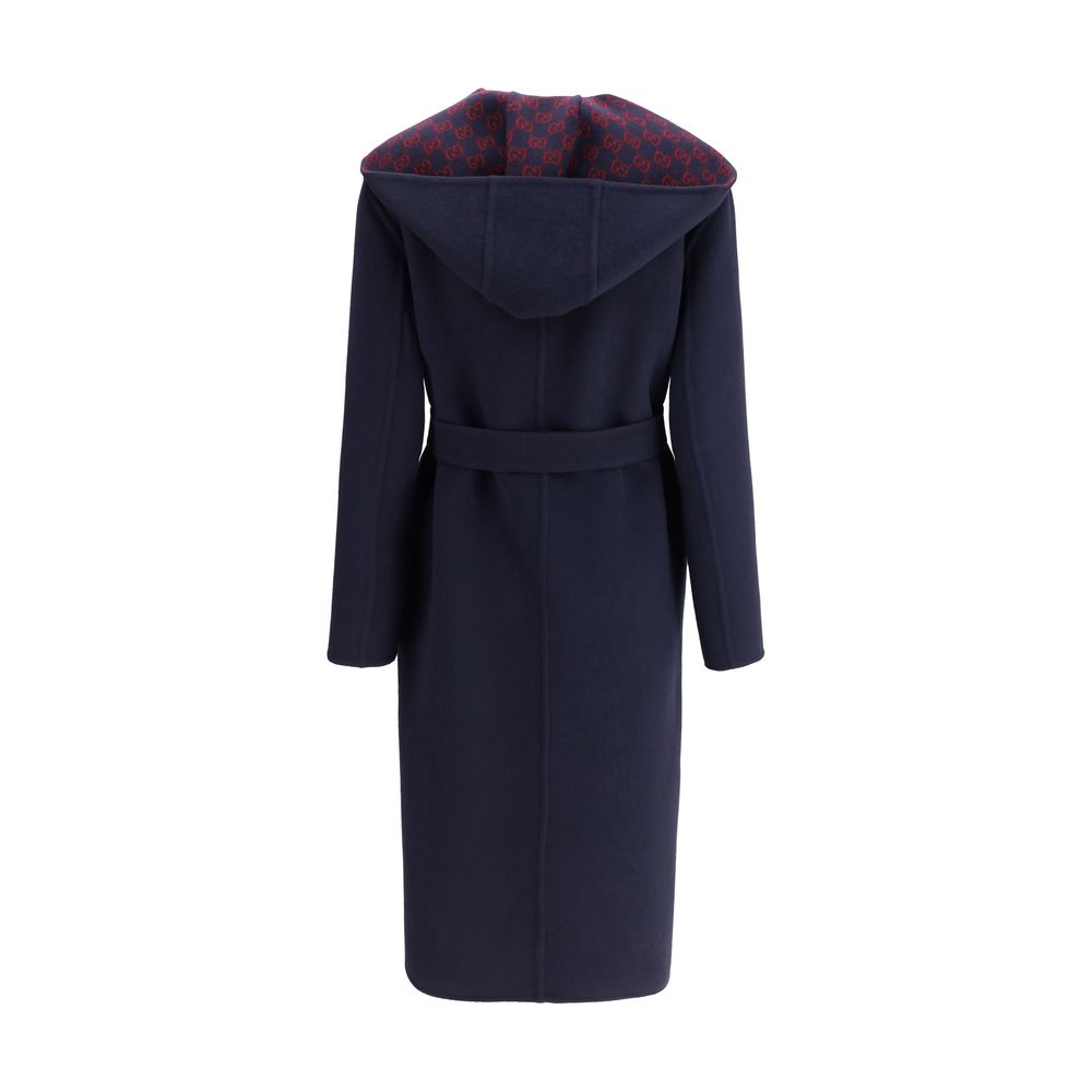 Back view of Gucci Blue Wool Coat with hood and sash, showcasing iconic Gucci monogram lining, elegant and functional design.