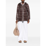 Model wearing Herno Coats Brown, chocolate brown midi down jacket with high-shine finish and two-way zip, holding beige bag.
