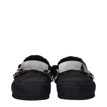 Jw Anderson Black Leather Slippers with fur lining, round toe, and silver side logo. Casual suede design with rubber sole.