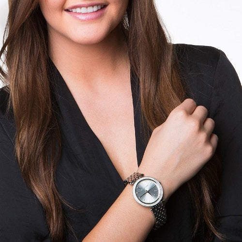 Woman wearing MICHAEL KORS WATCHES Mod. MK3190 with black outfit showcasing watch on wrist.