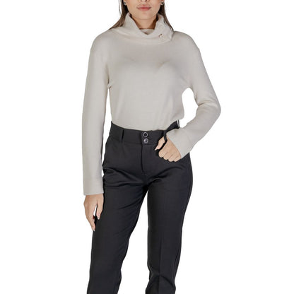 Woman wearing Street One Cream Viscose Turtleneck with stylish buttons and high neck, paired with black pants.