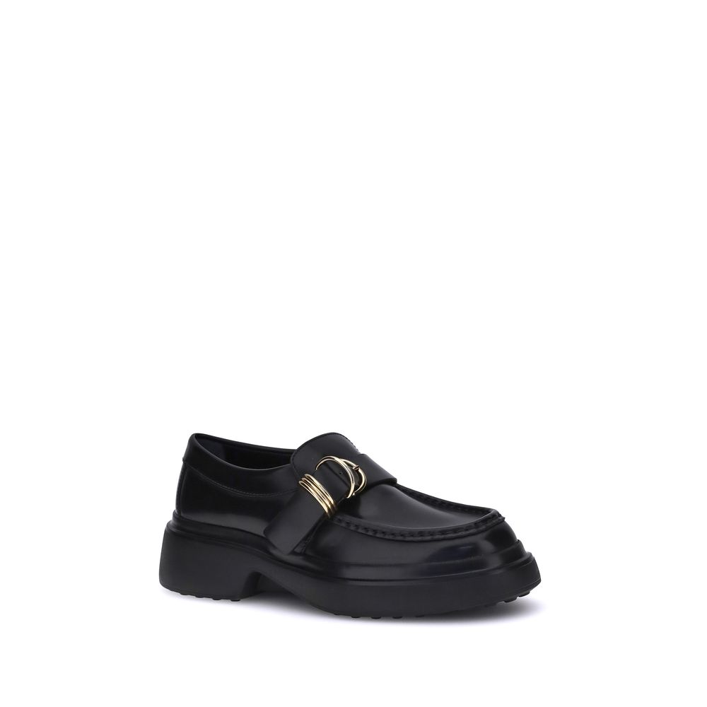 Tod's Black Rubber Platform Loafers with metal rings and nappa leather, showcasing a stylish and versatile choice for timeless elegance.