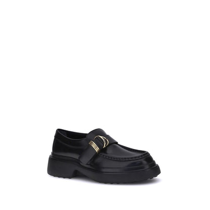 Tod's Black Rubber Platform Loafers with metal rings and nappa leather, showcasing a stylish and versatile choice for timeless elegance.