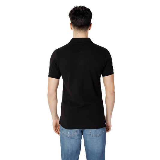 Back view of a man wearing Tommy Hilfiger Jeans Black Cotton Polo Shirt with short sleeves and blue jeans.