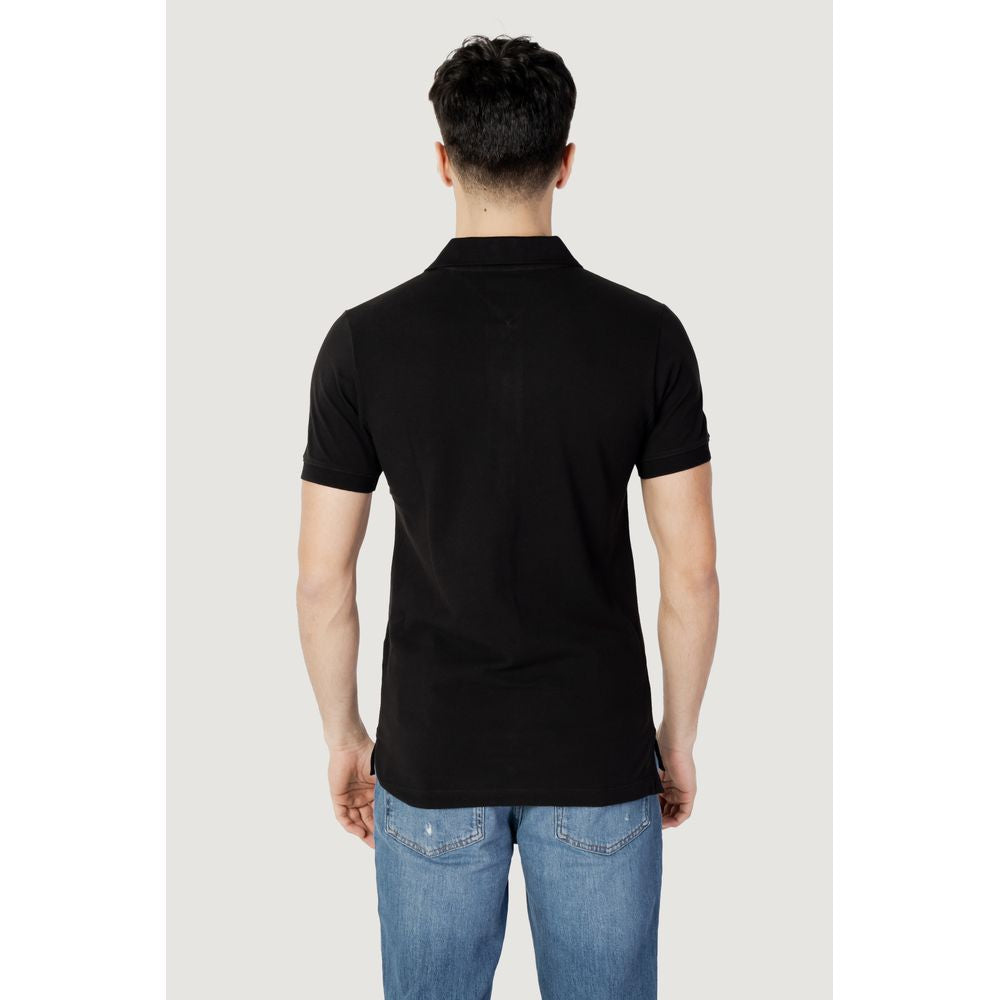 Back view of a model wearing Tommy Hilfiger Jeans Black Cotton Polo Shirt, short sleeves, slim-fit, classic collar.