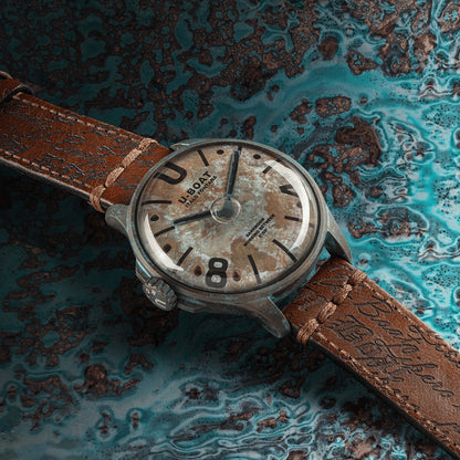 U-BOAT WATCHES Mod. 9600/A with a textured brown strap on a blue marble surface