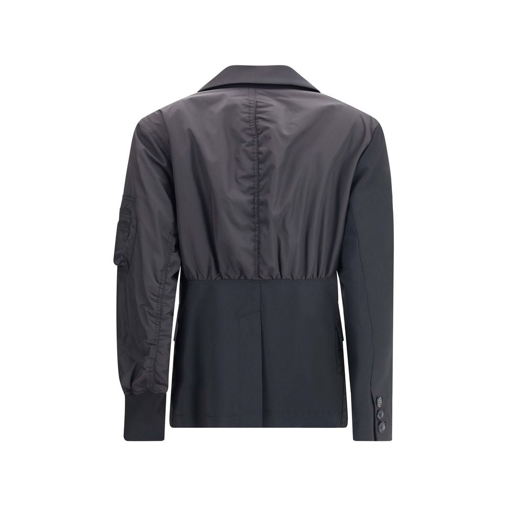 Back view of Undercover Black Polyester Bomber with shawl lapel, zippered sleeve pocket, and ribbed cuffs blending blazer and bomber styles.