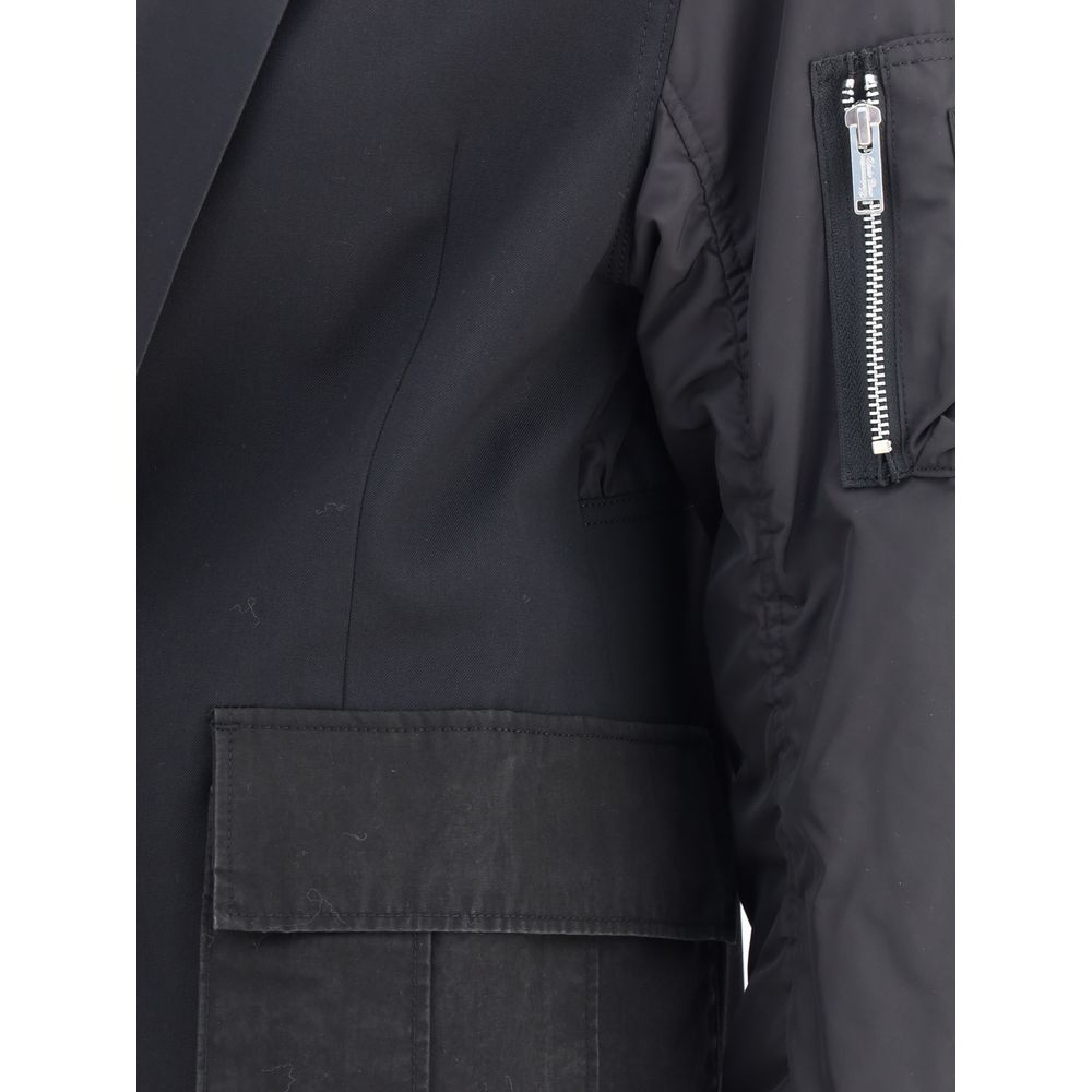Close-up of Undercover Black Polyester Bomber featuring a blazer design, zippered sleeve pocket, and ribbed cuffs.