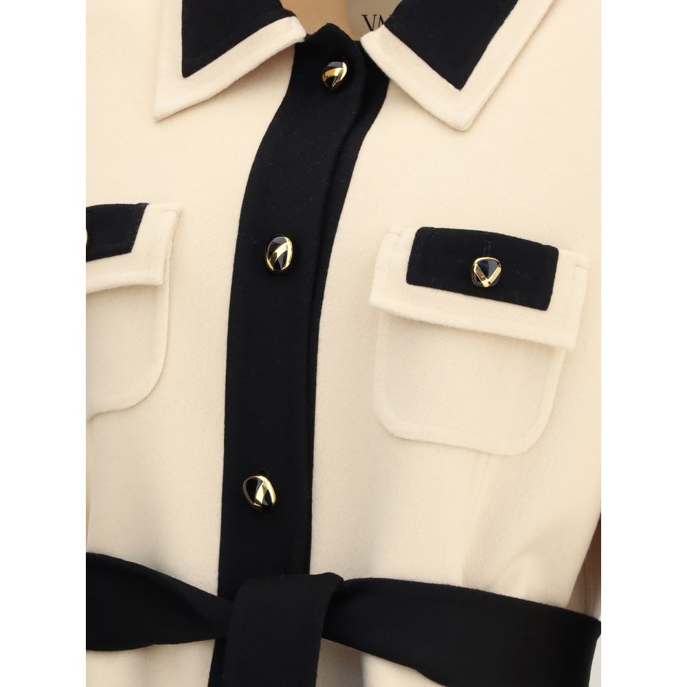 Close-up of Valentino Cream Fleece Wool Coat with black collar, buttons, and belt, highlighting elegant design details.