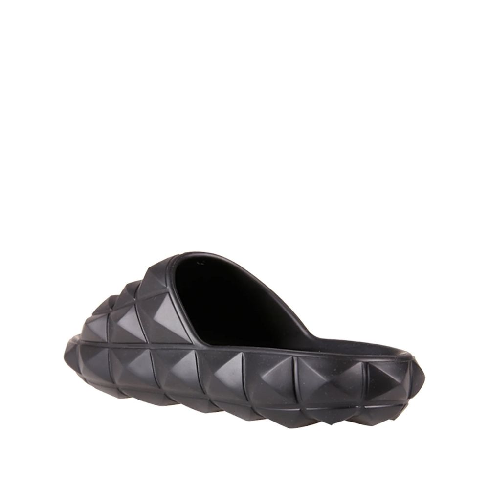 Valentino Garavani Black Rubber Slippers featuring all-over rubber studs, round open toe design, made in Italy for men.