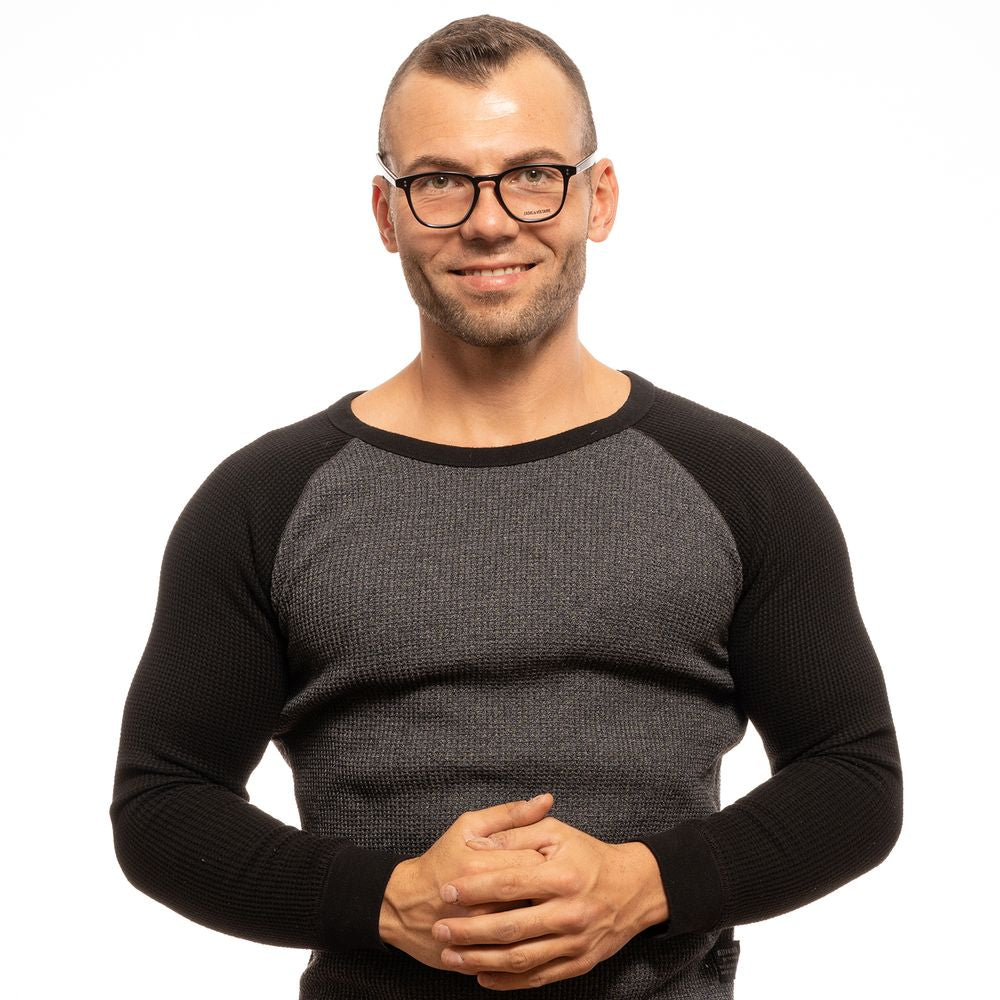 Man wearing Zadig & Voltaire Black Men Glasses Frame with trapezium full-rim style, standing against a white background.